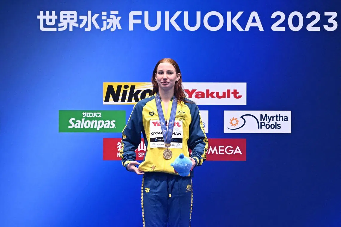 Gold medallist Mollie O'Callaghan poses during the medals ceremony for the women's 100m freestyle at the World Championships in Fukuoka, Japan.