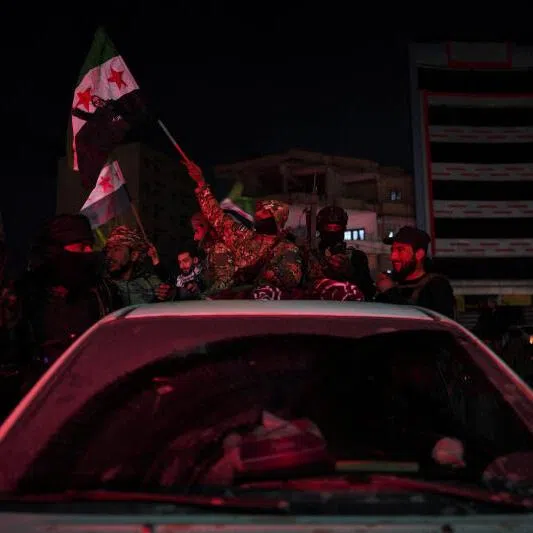 Syrian army personnel celebrate as government forces enter Raqqa city following the withdrawal of Syrian Democratic Forces.