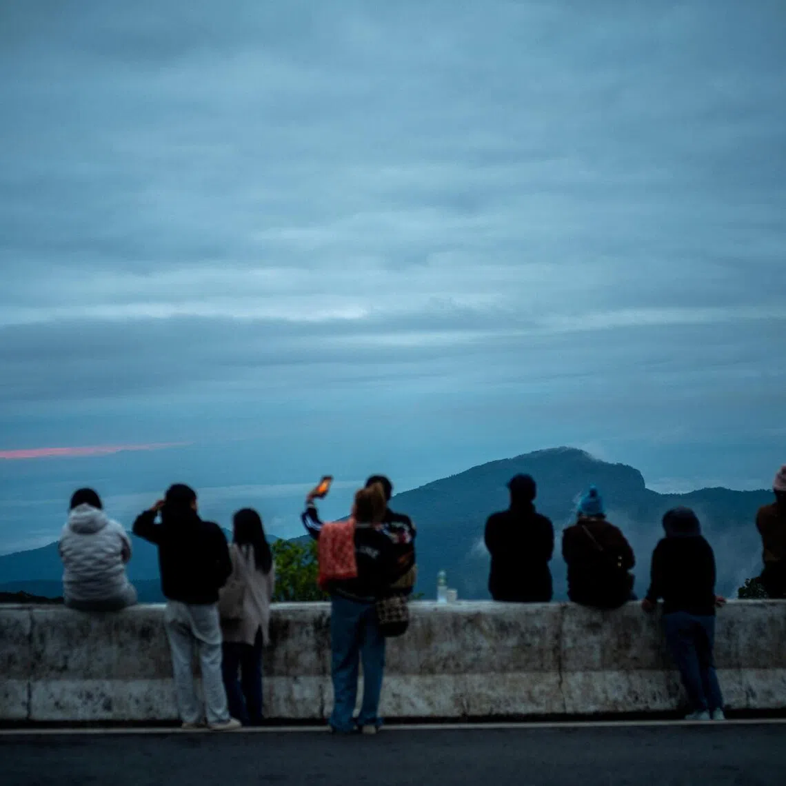 Tourists gather at a viewpoint in Chiang Mai province, northern Thailand.

