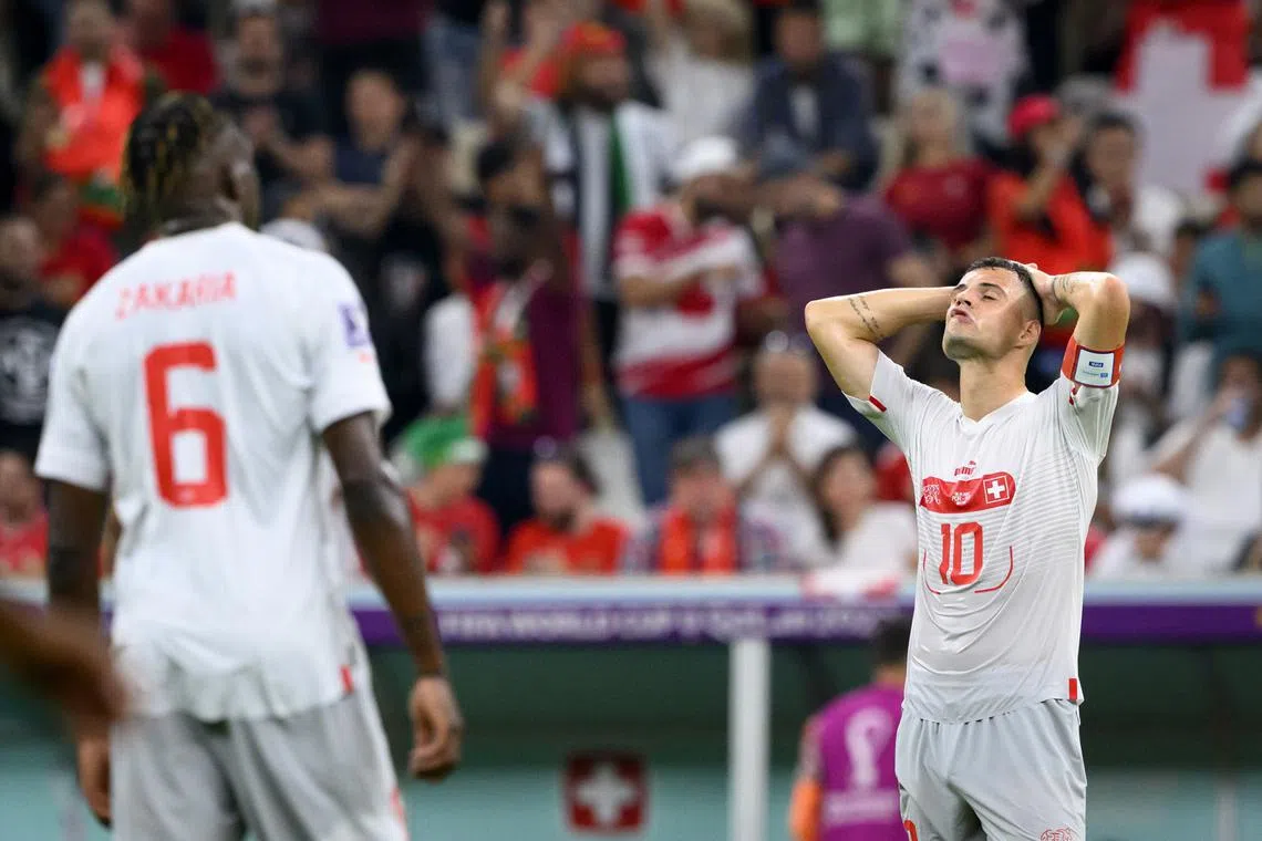 Switzerland's midfielder Granit Xhaka, right, and Switzerland's midfielder Denis Zakaria, left, react after their elimination during the FIFA World Cup Qatar 2022 round of 16 soccer match between Portugal and Switzerland at the Lusail Stadium in Lusail, north of Doha, Qatar, Dec 2022. Portugal won 6-1. 
