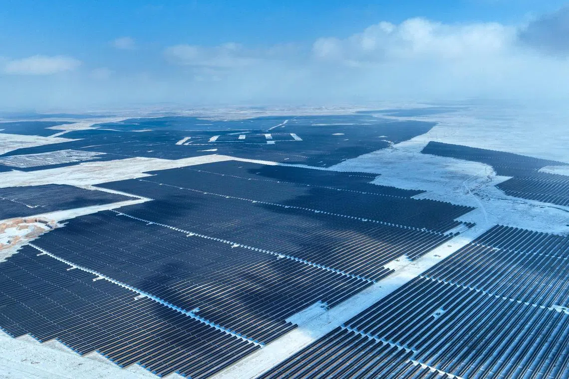 TOPSHOT - This aerial photo taken on January 21, 2024 shows solar panels in the snow-covered Gobi desert in Yinchuan, in China’s northern Ningxia region. (Photo by AFP) / China OUT