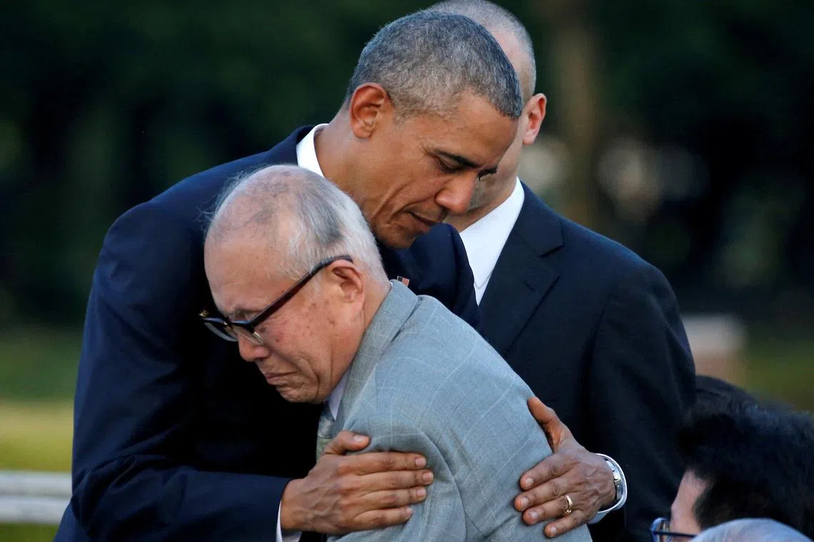 FILE PHOTO: U.S. President Barack Obama (L) hugs with atomic bomb survivor Shigeaki Mori as he visits Hiroshima Peace Memorial Park in Hiroshima, Japan May 27, 2016. REUTERS/Carlos Barria/File Photo