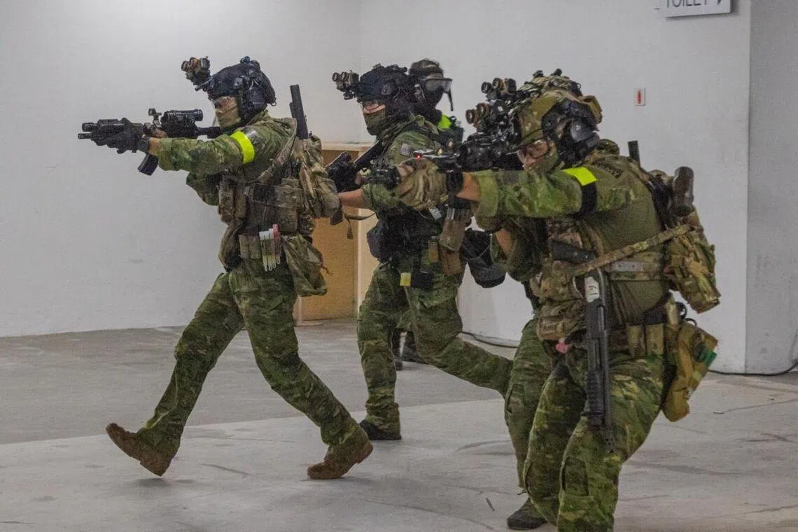 SAF’s Special Operations Task Force operators closing in on simulated terrorists during the exercise at the Home Team Tactical Centre.