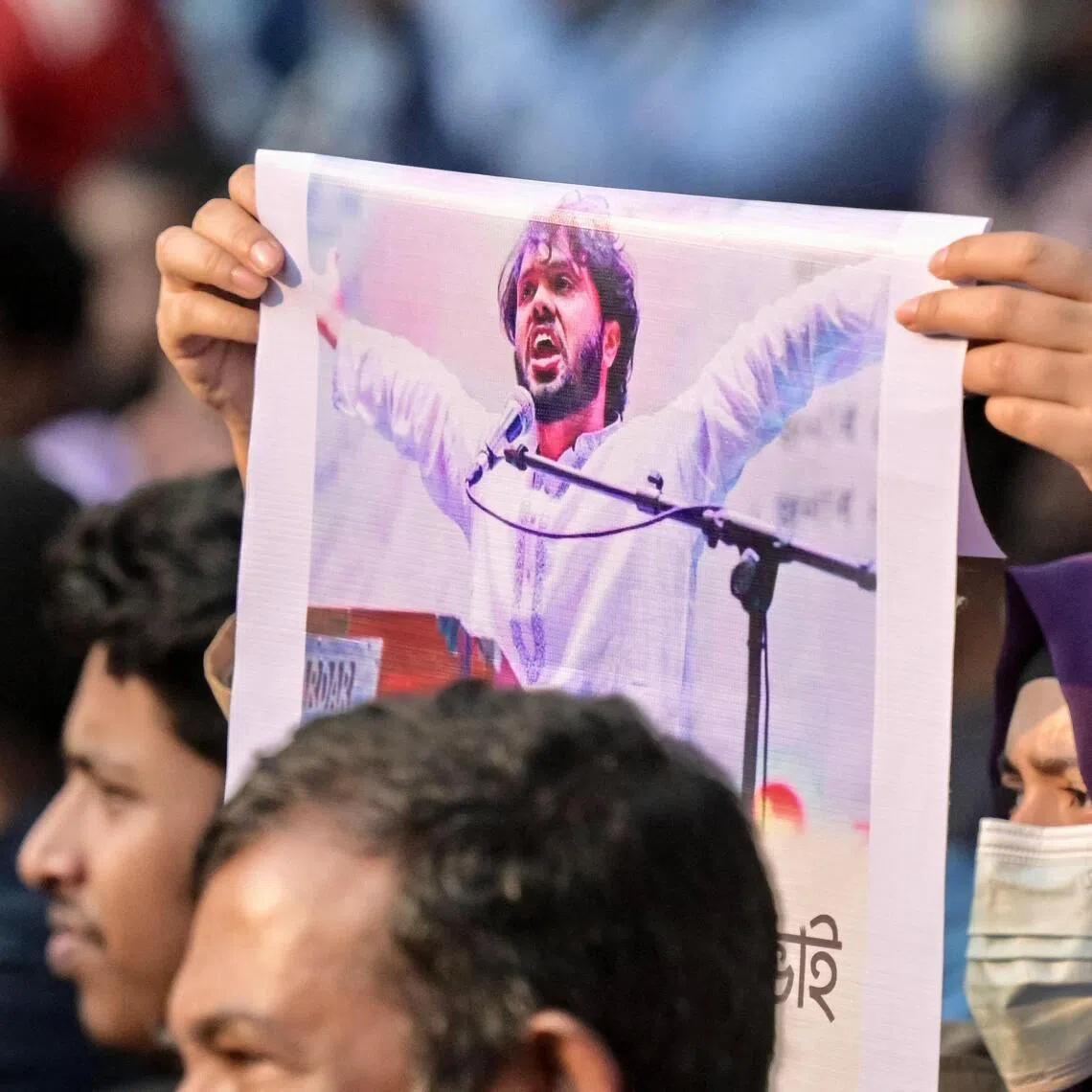 An activist holds a poster of Mr Sharif Osman Hadi, senior leader of the student protest group Inqilab Mancha, who was shot outside a mosque in Dhaka on Dec 12.