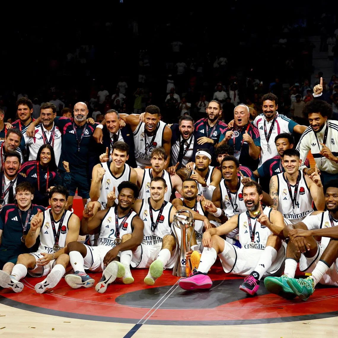 Real Madrid players and staff celebrate with the trophy after winning the Euroleague Basketball SuperCup at the Etihad Arena in Abu Dhabi on Sept 19.