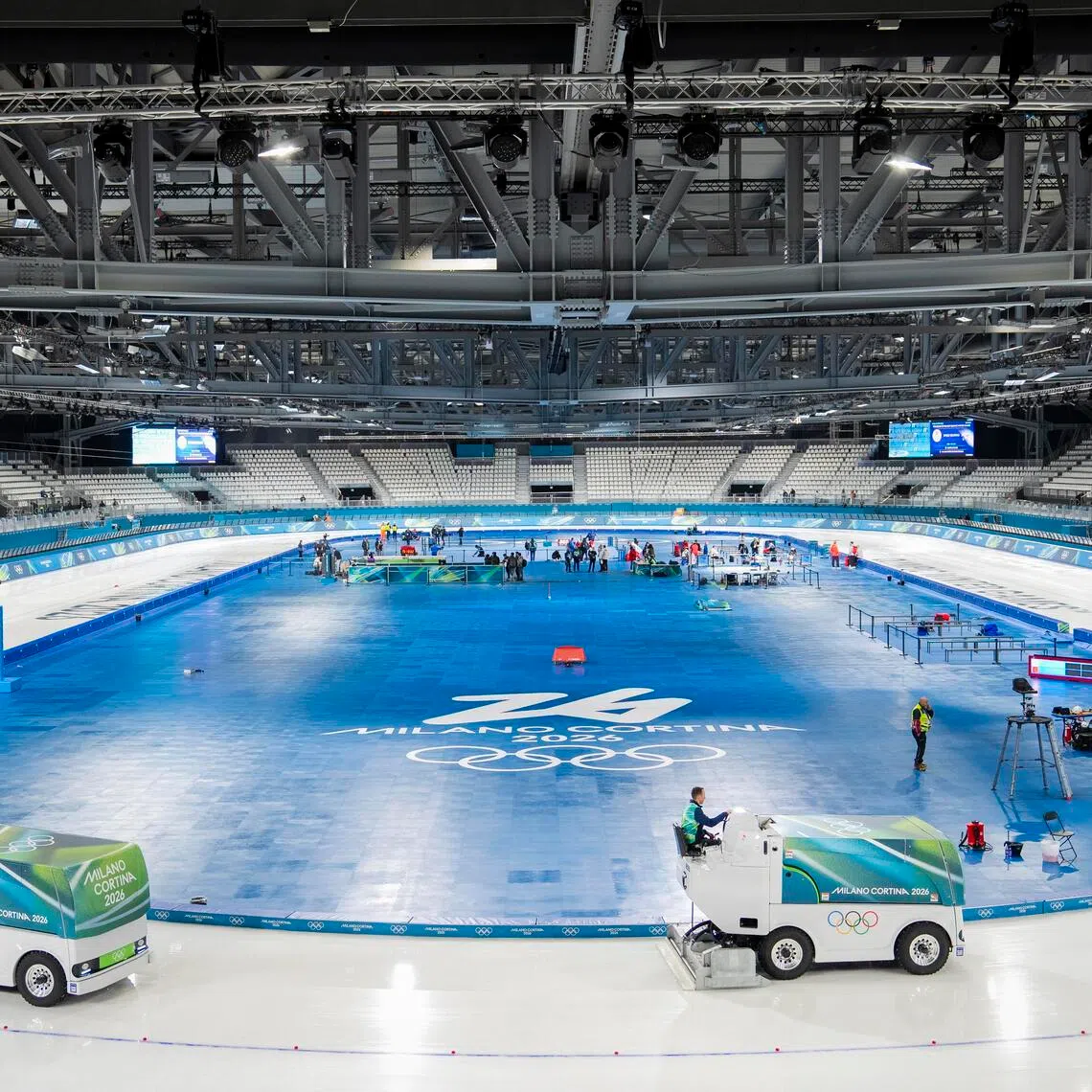 Workers resurface the ice at the speed skating stadium, a temporary venue, ahead of the 2026 Milan-Cortina Winter Olympics in Milan.