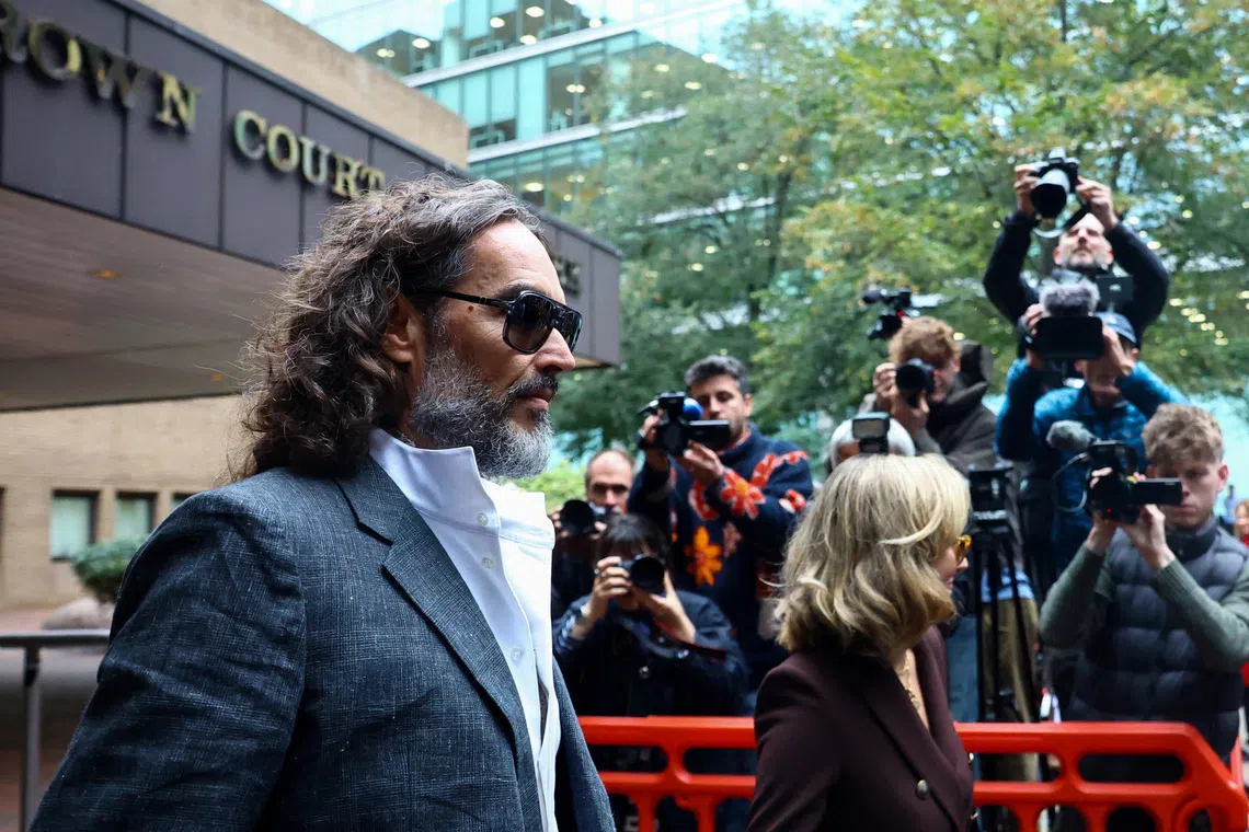 British actor and comedian Russell Brand and his wife Laura Brand leave Southwark Crown Court, where he is standing trial on charges of rape and sexual assault relating to six women, which he denies, in London, Britain, October 12, 2026. REUTERS/Hannah McKay