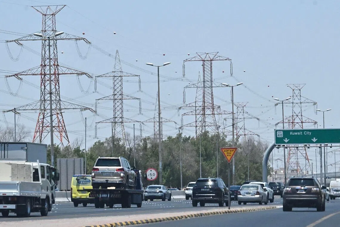 Vehicles drive along a highway on the outskirts of Kuwait City on July 8.