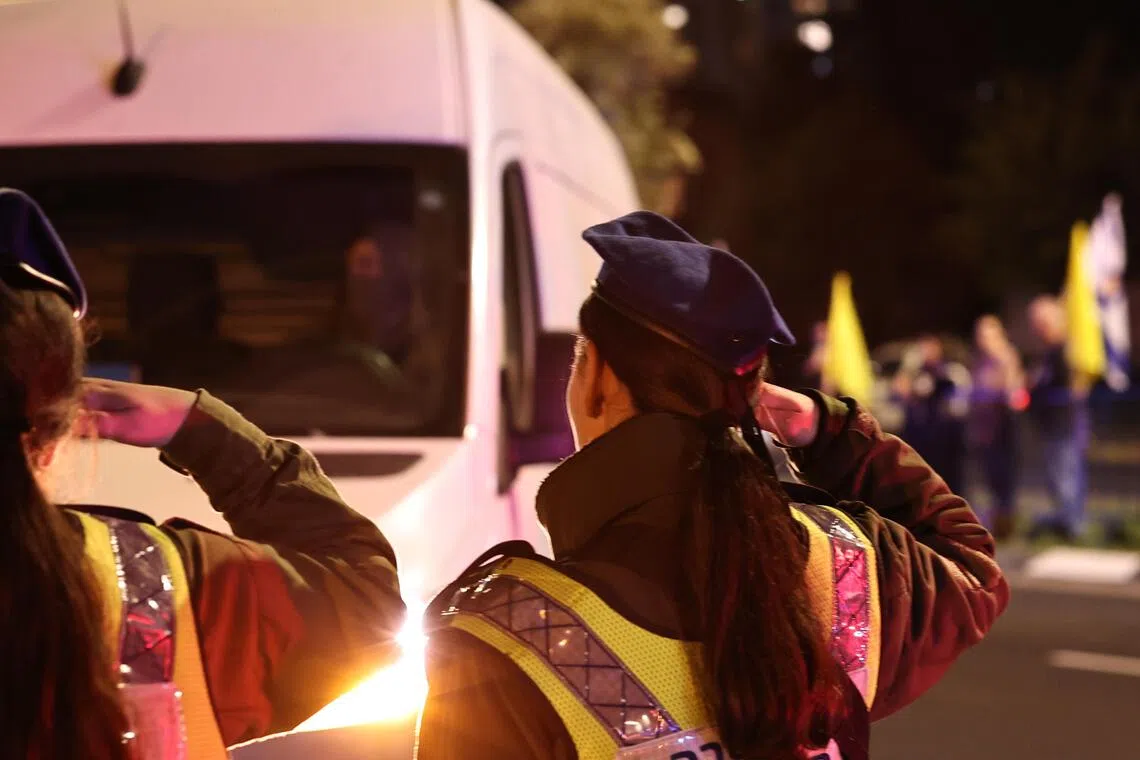 Israeli soldiers salute as a convoy, carrying the body of a hostage handed over by Hamas, arrives at the National Centre of Forensic Medicine in Tel Aviv, Israel on Nov 13, 2025.  