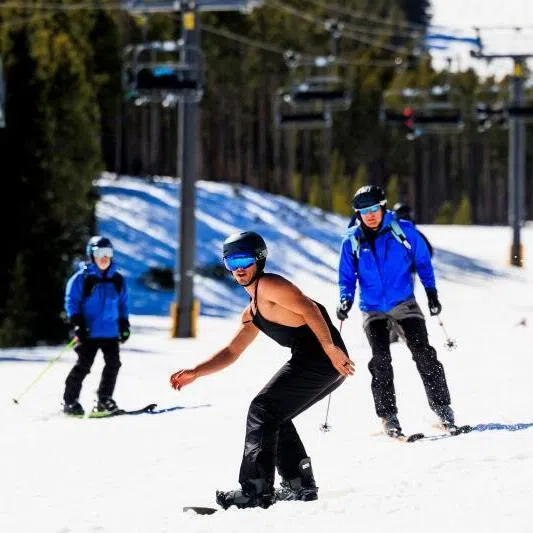 A man snowboards without his coat at Breckenridge Ski Resort as temperatures reach into the 50s on March 18 in Breckenridge, Colorado. 