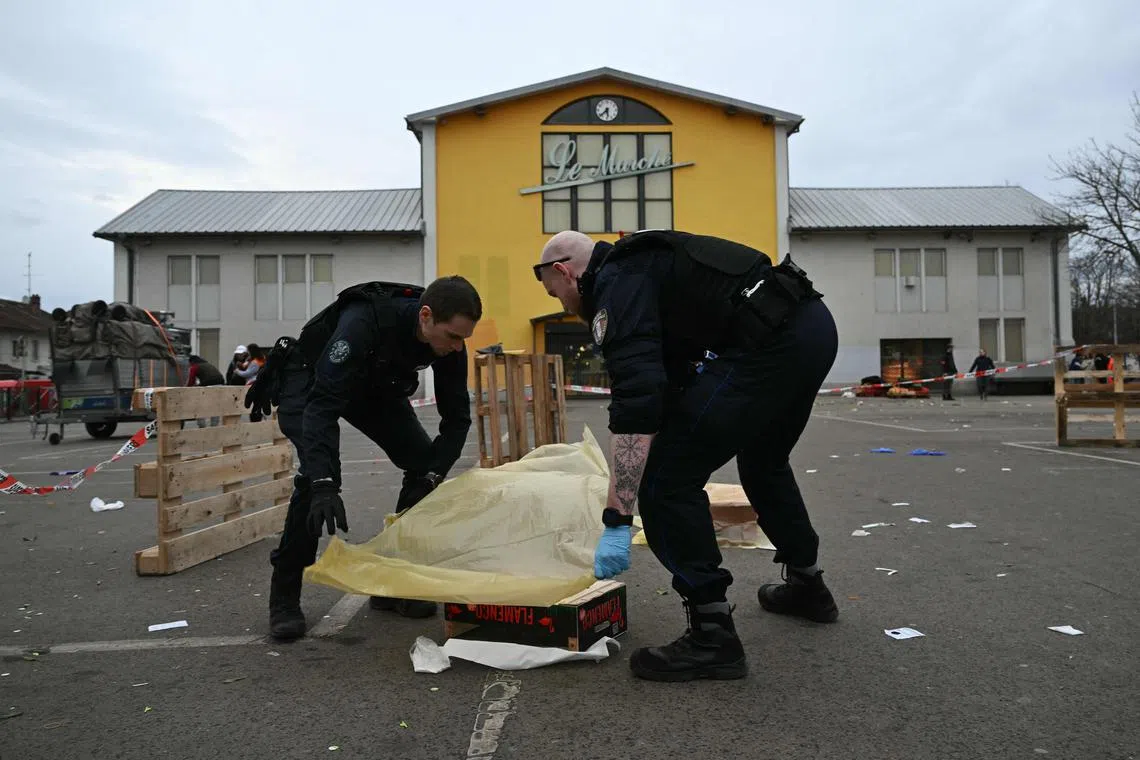 Police officers collecting evidence at the site of a knife attack in Mulhouse, eastern France, on Feb 22.