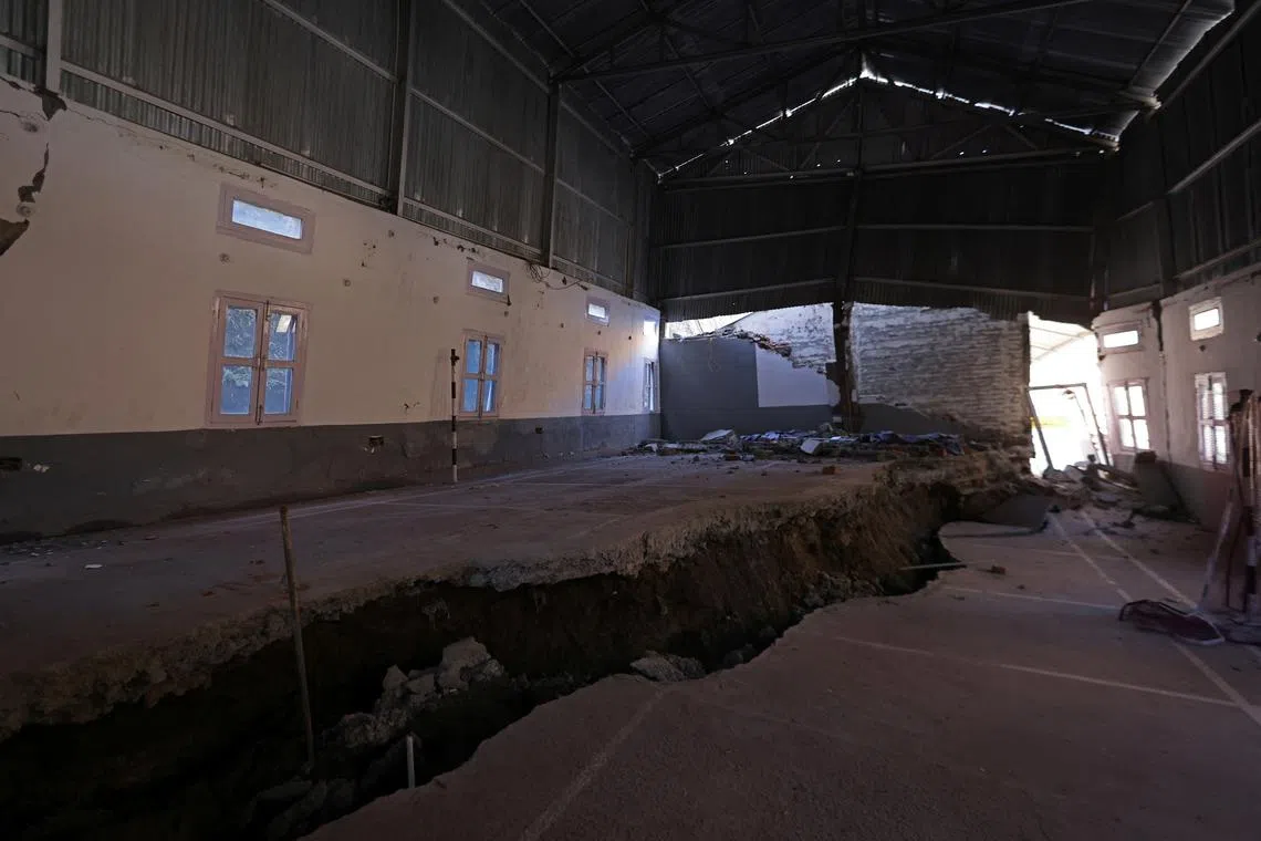 A large crack divides the floor of a badminton court floor, which was part of a residential complex for workers at Jaypee, a construction and power company, in Joshimath, in the northern state of Uttarakhand, India, Jan 15, 2023. After the cracks appeared in the complex following rapid urban expansion, the residents were moved out.    