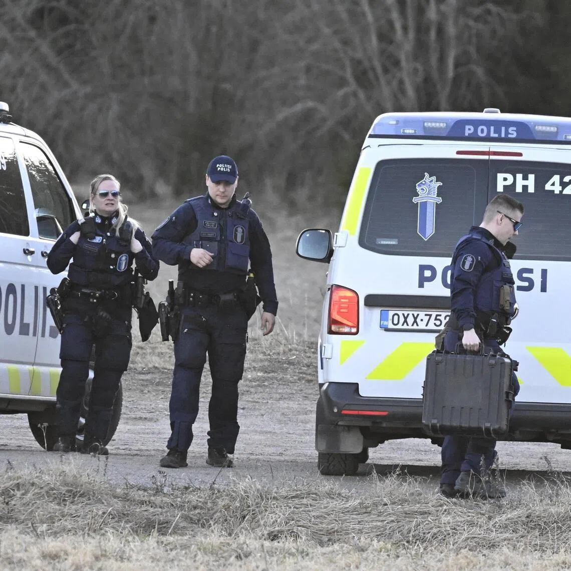 Police officers guarding a closed-off area, after a crashed drone was found in the woods, in Iitti, Finland, on April 11.