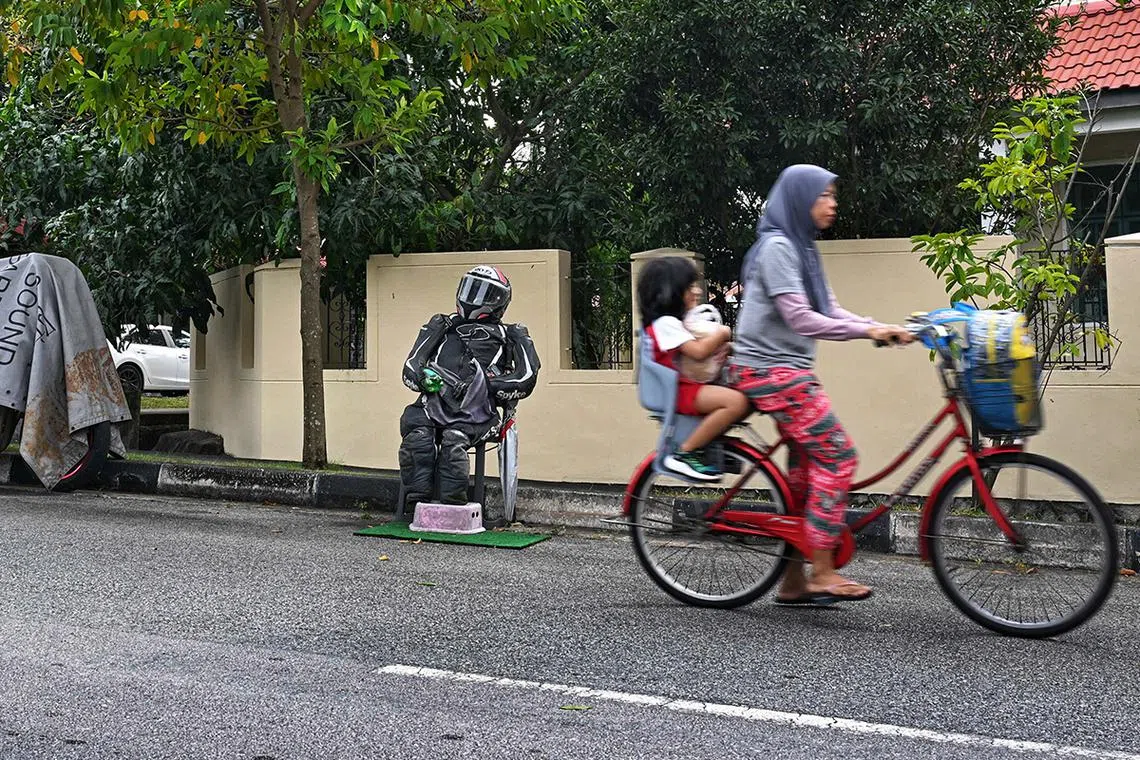 A rudimentary mannequin dressed in a biker suit and helmet serves as informal rally / ? chope ? point for motorcyclists to park their bikes at Punggol Seventeen Avenue seen on Jan 9, 2024.