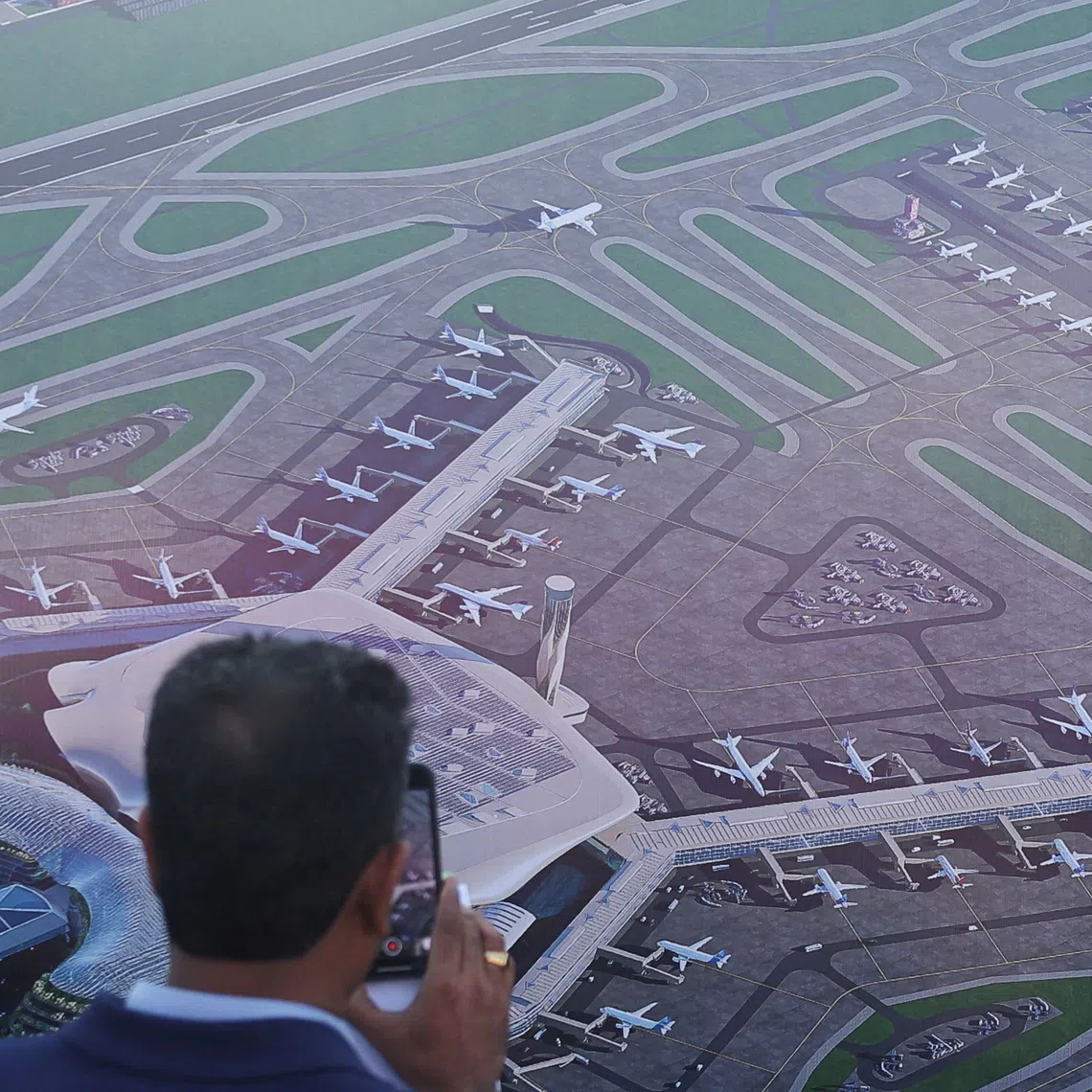 The plan involves adding terminals, taxiways and a runway at the Navi Mumbai airport, which is set to open on Dec 25, sources said.