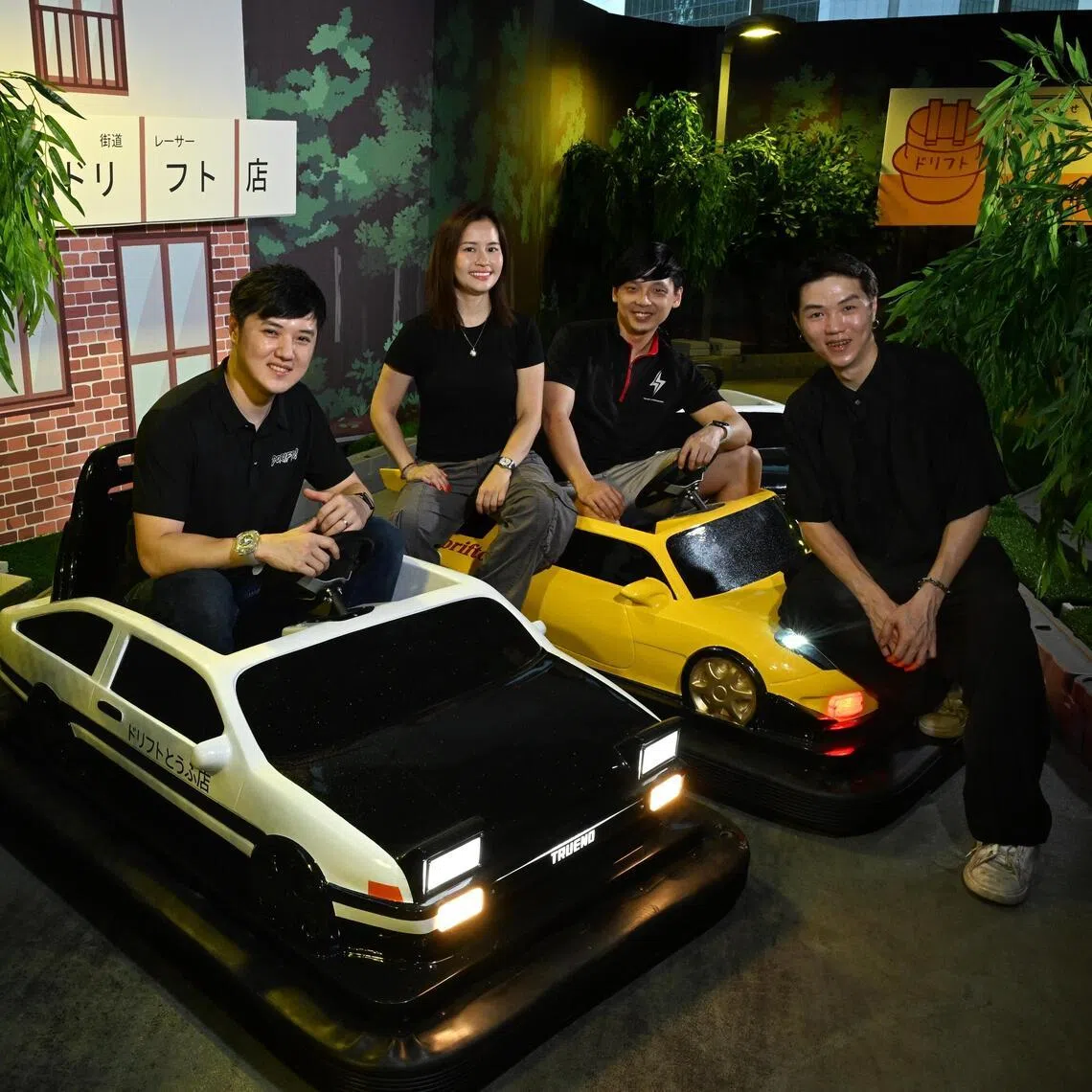 from left: Dorifto! co-founders Shane Ang, Gladys Lam, Kenneth Ho and Shawn Ang with the drift karts styled after the Toyota AE86 and Mazda RX-7 at the indoor drift circuit on April 14, 2026.