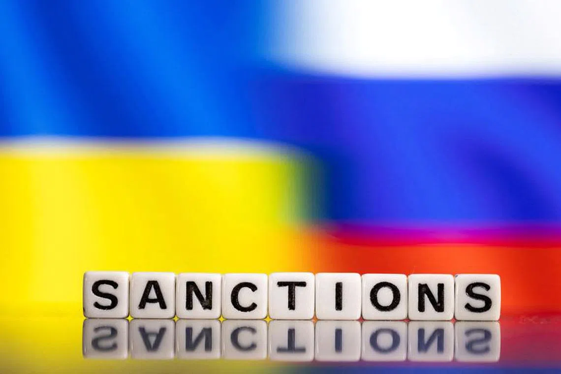 FILE PHOTO: Plastic letters arranged to read \"Sanctions\" are placed in front of Ukraine's and Russia's flag colors  in this illustration taken February 25, 2022. REUTERS/Dado Ruvic/Illustration/File Photo