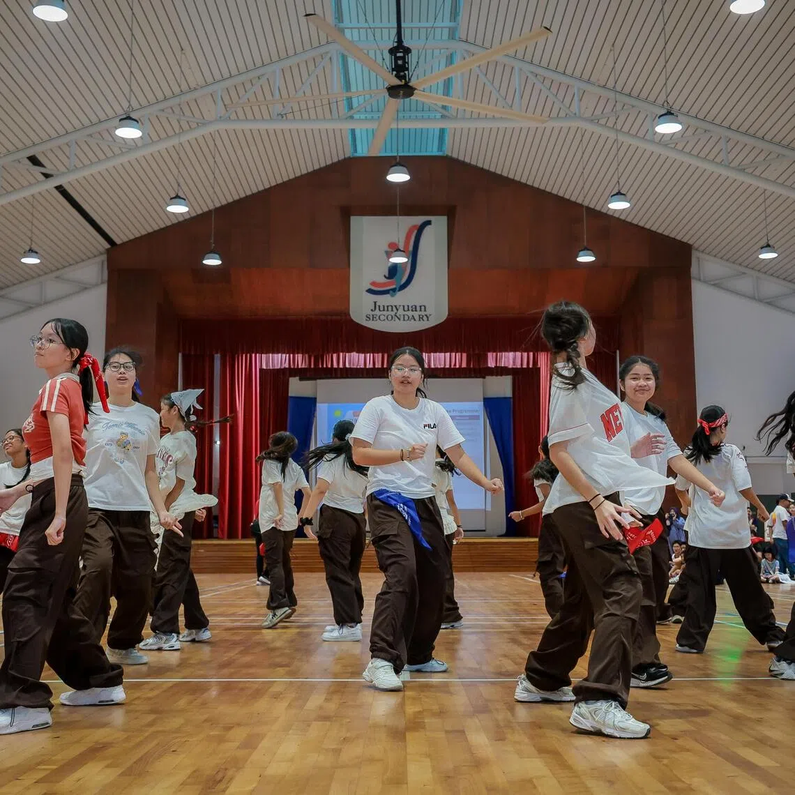 Students from the Modern Dance CCA (co-curricular activity) performing at the open house at Junyuan Secondary School on Nov 22, 2025.  Open houses, which give visitors an idea of the school's learning environment and culture, can be useful in helping post-PSLE students find a secondary school that is a good fit for them.