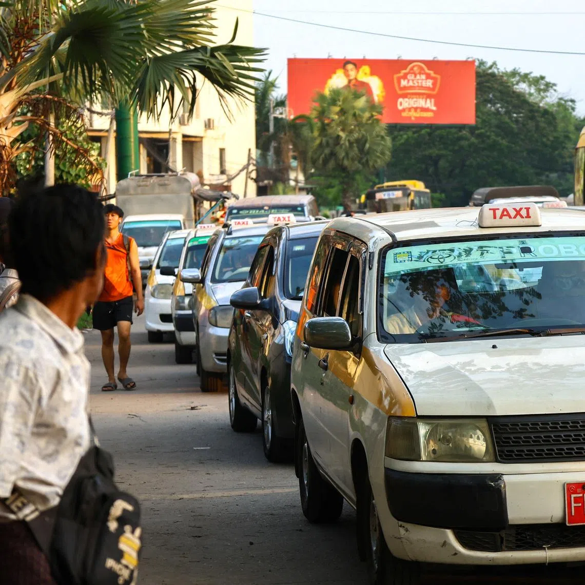 Drivers queue to fill fuel at a gas station in Yangon on March 20. Farmers in Myanmar also struggling with rising costs of diesel and fertilisers. 