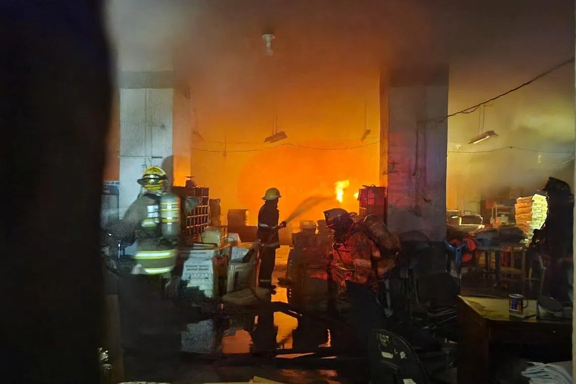Firefighters work at the scene of a massive fire at the Manila Central Post Office building in Manila, Philippines, May 22, 2023. 