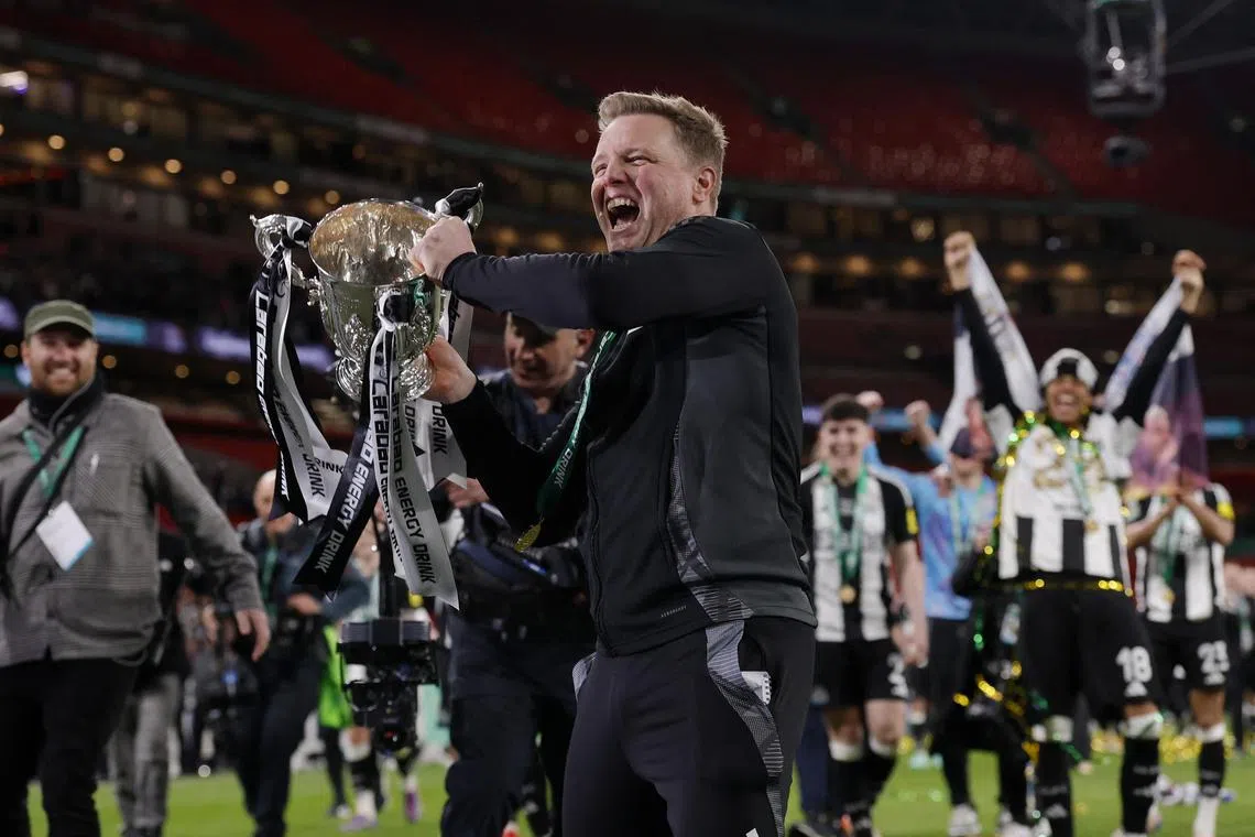 Soccer Football - Carabao Cup - Final - Liverpool v Newcastle United - Wembley Stadium, London, Britain - March 16, 2025
Newcastle United manager Eddie Howe celebrates with the trophy after winning the Carabao Cup Action Images via Reuters/Andrew Couldridge EDITORIAL USE ONLY. NO USE WITH UNAUTHORIZED AUDIO, VIDEO, DATA, FIXTURE LISTS, CLUB/LEAGUE LOGOS OR 'LIVE' SERVICES. ONLINE IN-MATCH USE LIMITED TO 120 IMAGES, NO VIDEO EMULATION. NO USE IN BETTING, GAMES OR SINGLE CLUB/LEAGUE/PLAYER PUBLICATIONS. PLEASE CONTACT YOUR ACCOUNT REPRESENTATIVE FOR FURTHER DETAILS..