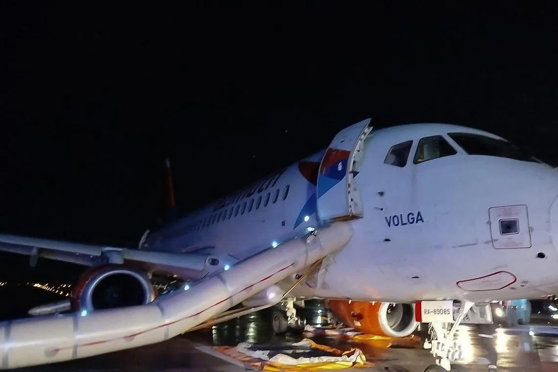 This photograph taken and released on November 24, 2024 by Turkish news agency DHA (Demiroren News Agency) shows the Russian Azimut airlines Sukkohoi Superjet 100-95RL passenger airplane after the fire on one of its engines was set off and 79 passengers were evacuated via emergency slides from the aircraft on the tarmac of Antalya Airport. (Photo by STRINGER / DHA (Demiroren News Agency) / AFP) / Turkey OUT / RESTRICTED TO EDITORIAL USE - MANDATORY CREDIT "AFP PHOTO /  DHA (Demiroren News Agency) " - NO MARKETING NO ADVERTISING CAMPAIGNS - DISTRIBUTED AS A SERVICE TO CLIENTS