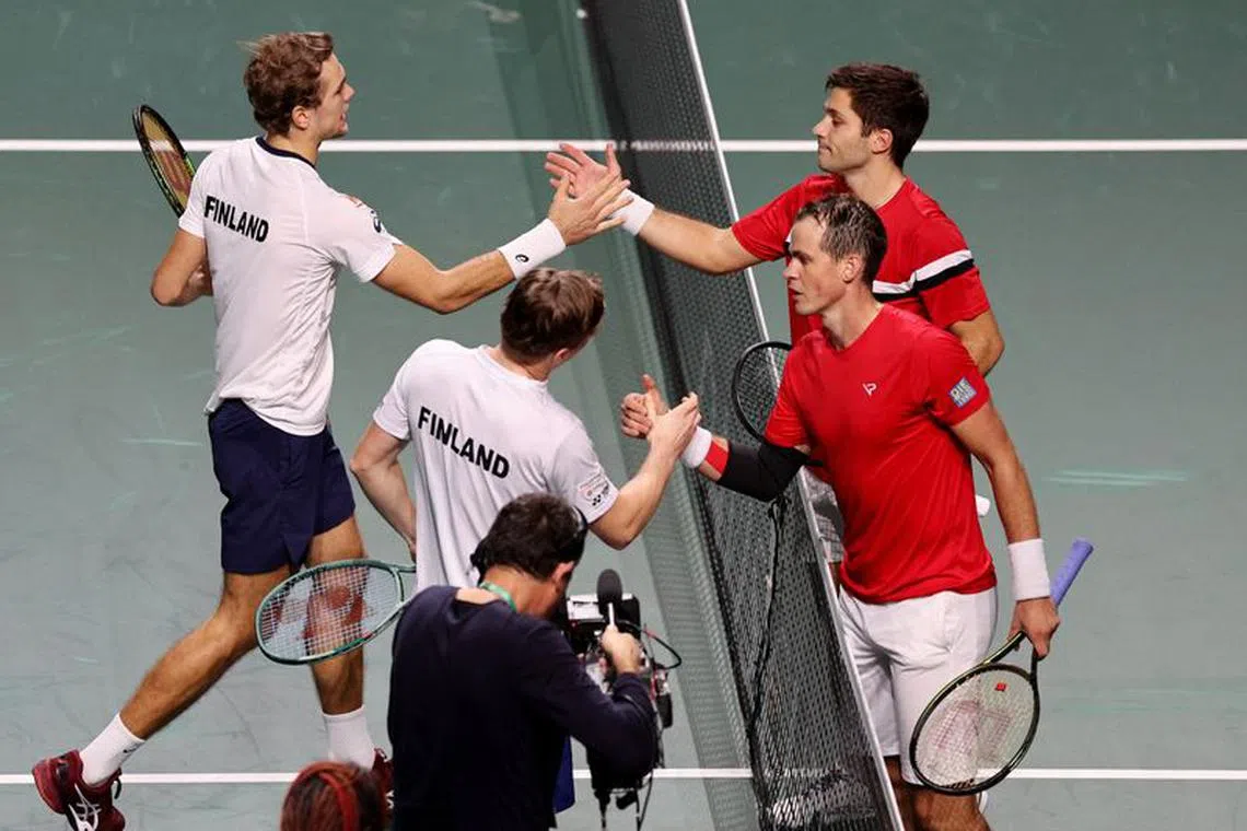 Tennis - Davis Cup - Finals - Canada v Finland - Palacio de deportes Martin Carpena, Malaga, Spain - November 21, 2023   Finland's Harri Heliovaara and Otto Virtanen shake hands with Canada's Alexis Galarneau and Vasek Pospisil after their quarter final doubles match REUTERS/Violeta Santos Moura