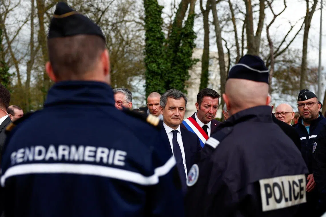 French Interior Minister Gerald Darmanin talks to French Gendarmes and police after a dynamic demonstration of the safety system during the Olympic flame journey.