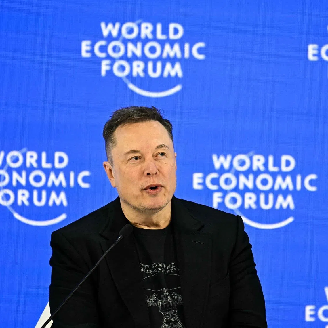 (FILES) CEO of SpaceX and Tesla, South African-Canadian-US businessman Elon Musk speaks during the World Economic Forum (WEF) annual meeting in Davos on January 22, 2026. Tesla reported higher first-quarter profits Wednesday, pointing to recovering demand in North America as it pursues significant investments in autonomous transport and artificial intelligence. (Photo by Fabrice COFFRINI / AFP)