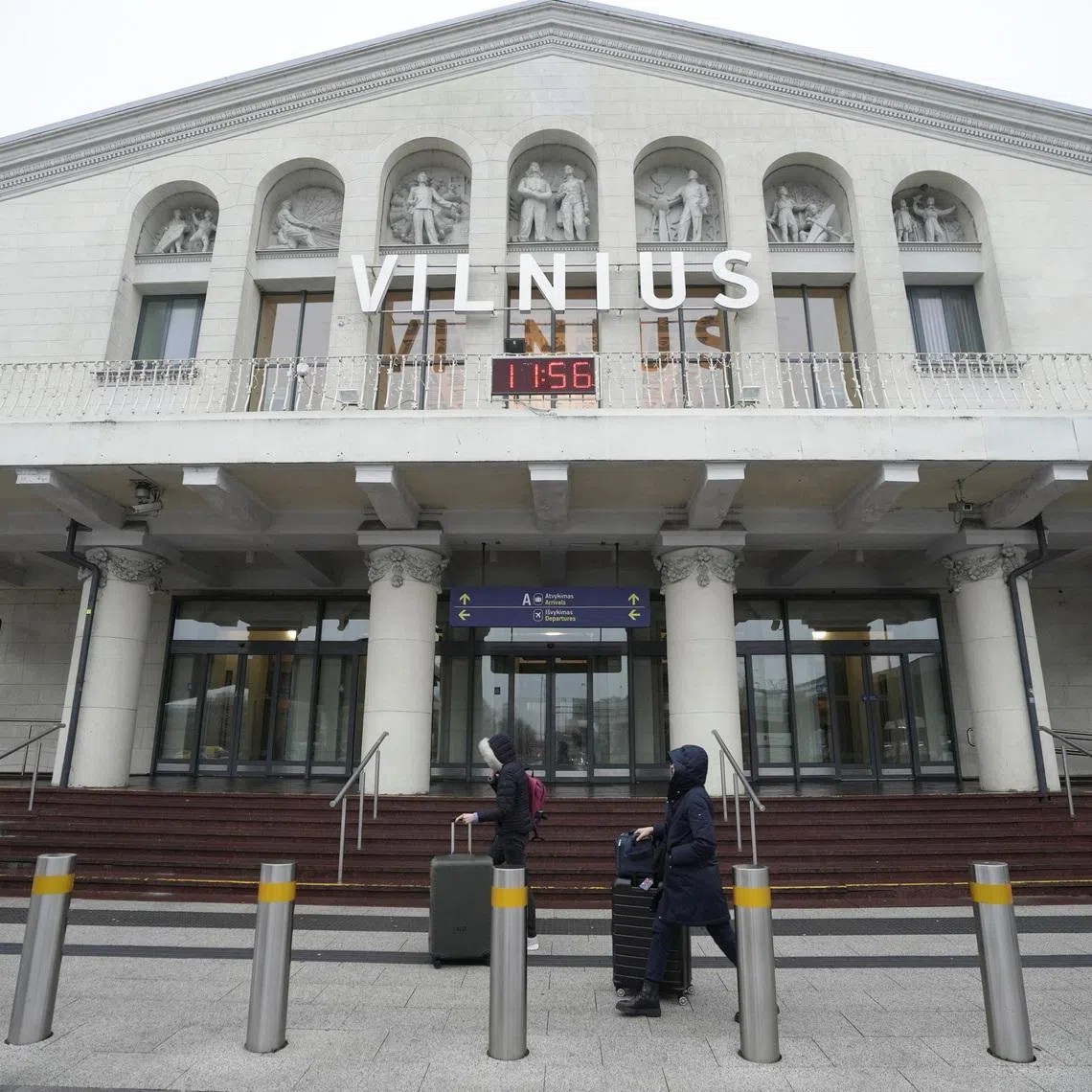 Passengers walk past the arrival terminal in Vilnius Ciurlionis International Airport in Vilnius, Lithuania, December 9, 2025. REUTERS/Janis Laizans