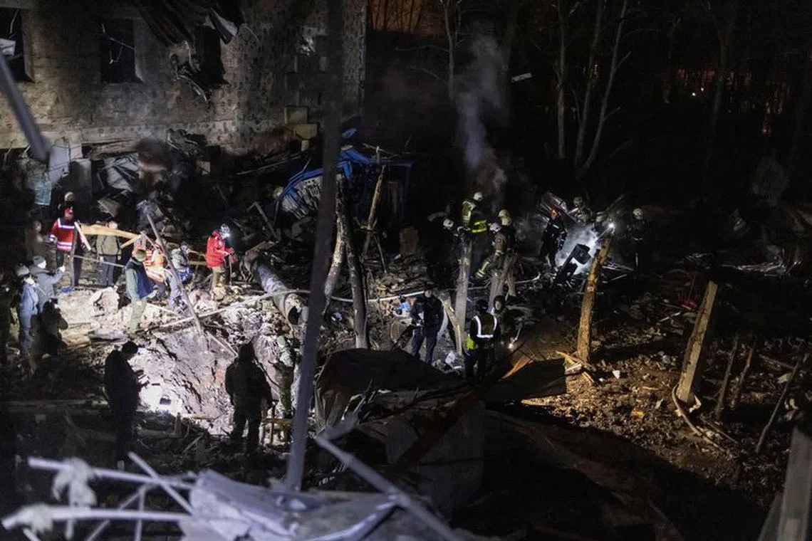 Firefighters and police investigators work at the site of a Russian missile strike, amid Russia's attack on Ukraine, in Kharkiv, Ukraine December 30, 2023. REUTERS/Yevhen Titov