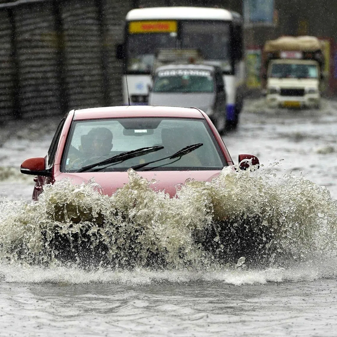 Vehicles wade through a waterlogged street after heavy monsoon rains in Ajmer, India, on July 22.
