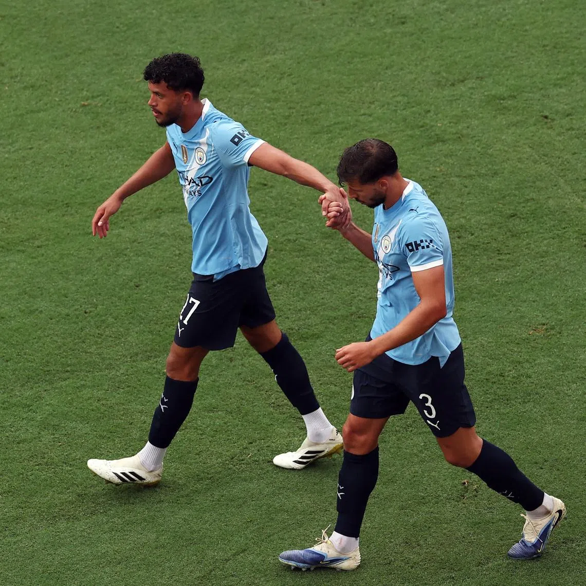 FILE PHOTO: Soccer Football - FIFA Club World Cup - Group G - Juventus v Manchester City - Camping World Stadium, Orlando, Florida, U.S. - June 26, 2025 Manchester City's Matheus Nunes and Manchester City's Ruben Dias celebrate their third goal scored by Manchester City's Erling Haaland REUTERS/Amanda Perobelli/File Photo