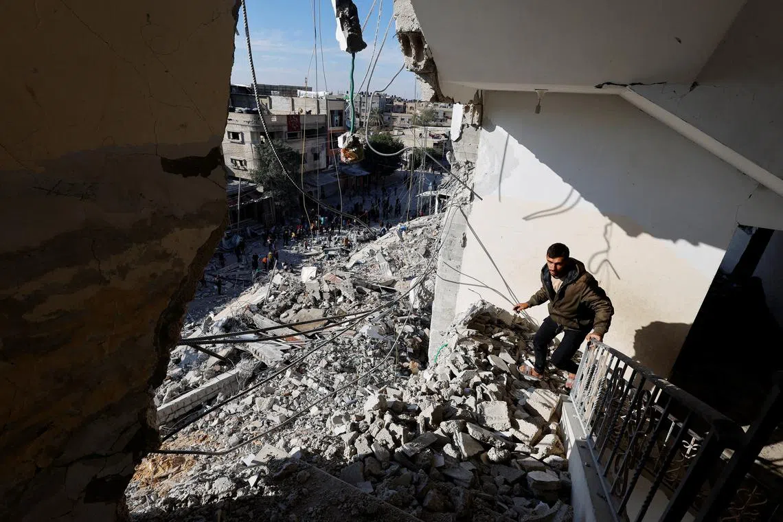 FILE PHOTO: A Palestinian man walks through the rubble of a building damaged in an Israeli air strike, amid the ongoing conflict between Israel and the Palestinian Islamist group Hamas, in Rafah, in the southern Gaza Strip March 9, 2024. REUTERS/Mohammed Salem/File Photo