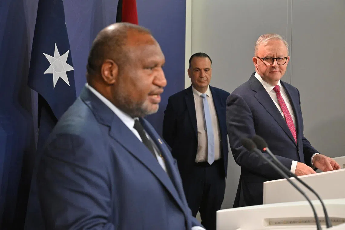 Papua New Guinea Prime Minister James Marape speaking as Australian Prime Minister Anthony Albanese and Australian Rugby League Commission chairman Peter V'landys listen at a press conference in Sydney on Dec 12, 2024.