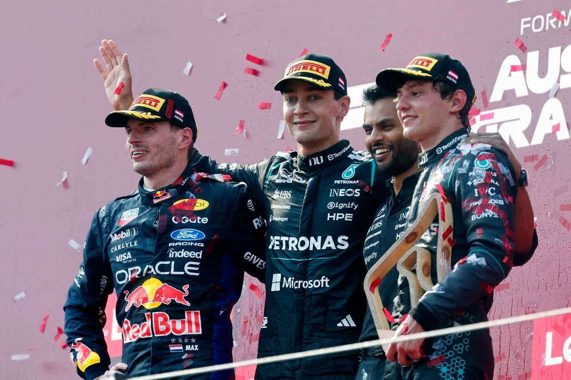 Mercedes’ George Russell celebrates on the podium after winning the Austrian Grand Prix alongside second placed Red Bull’s Max Verstappen (left) and third placed Mercedes’ Andrea Kimi Antonelli and Mercedes engineer Arun Rajkumar.