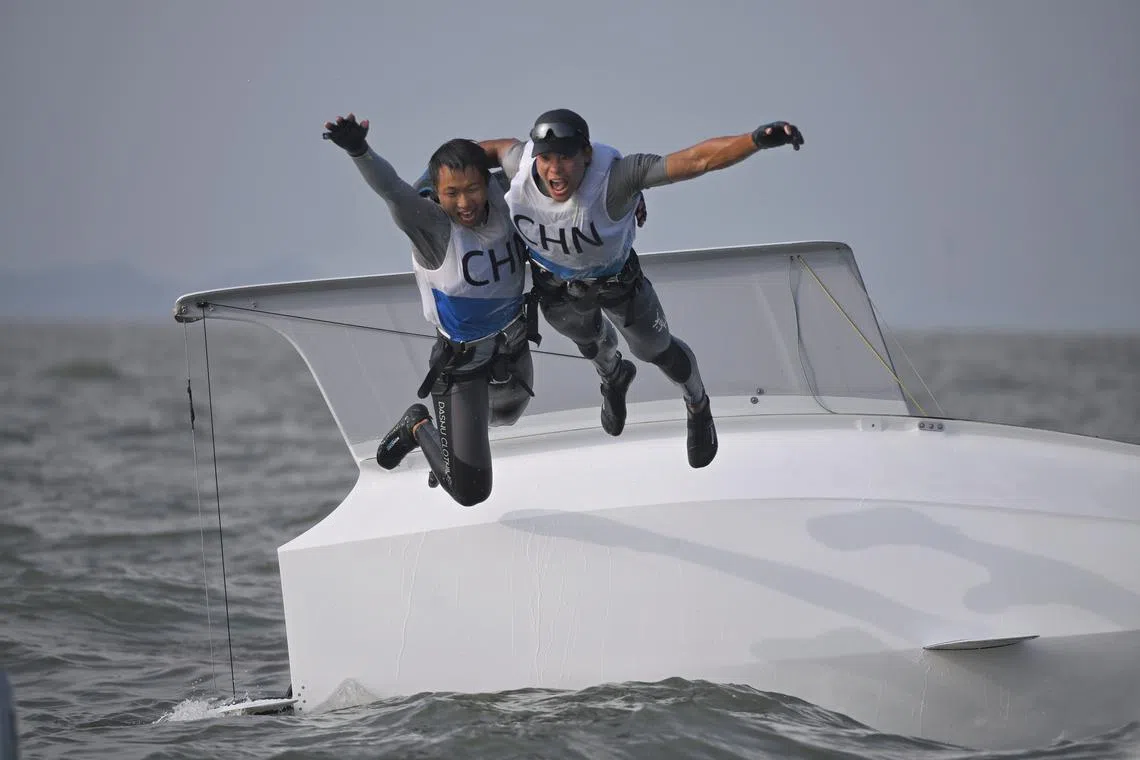 China's Wen Zaiding and Tian Liu celebrating after the Men's Skiff 49er Race in Ningbo Xiangshan Sailing Centre on Sept 26.
