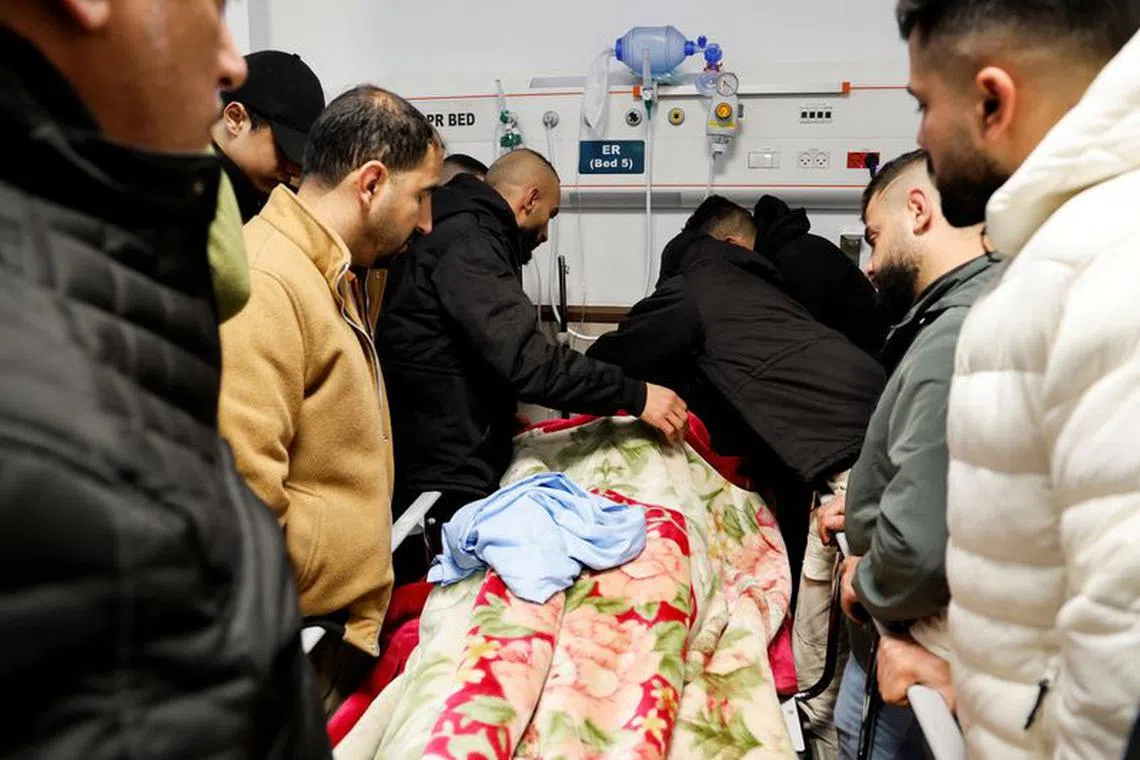 Mourners react next to the body of a Palestinian killed following an Israeli raid, in a hospital in Jenin, in the Israeli-occupied West Bank January 30, 2024. REUTERS/Raneen Sawafta