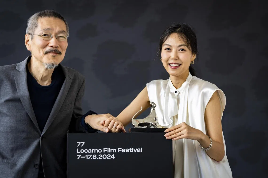 South Korean actress Kim Min-hee (right) poses with the Best Performance Award next to director Hong Sang-soo at the 77th Locarno International Film Festival in August 2024.