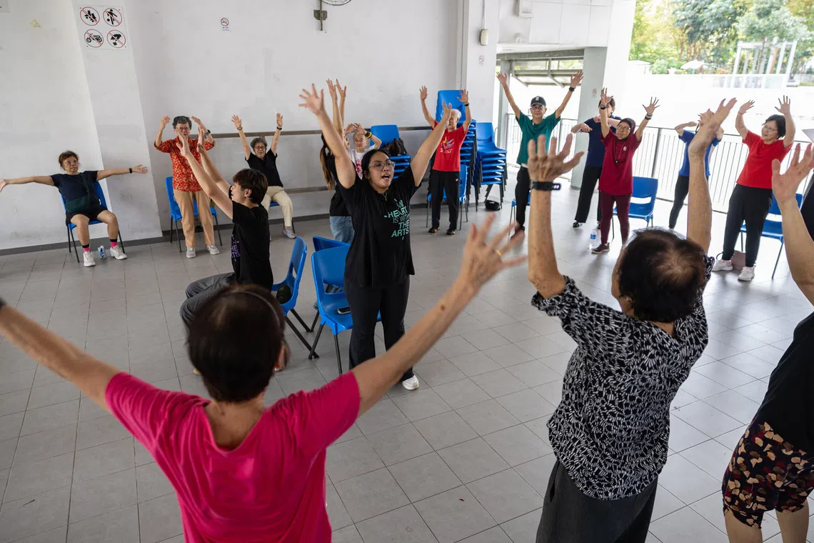 Student trainers Ashley Ng, Shyann Loh and Nureen Binte Abdul Aziz guiding seniors at the launch of a large-scale intergenerational community dance programme by NUS Nursing and Lions Befrienders on Sept 30.