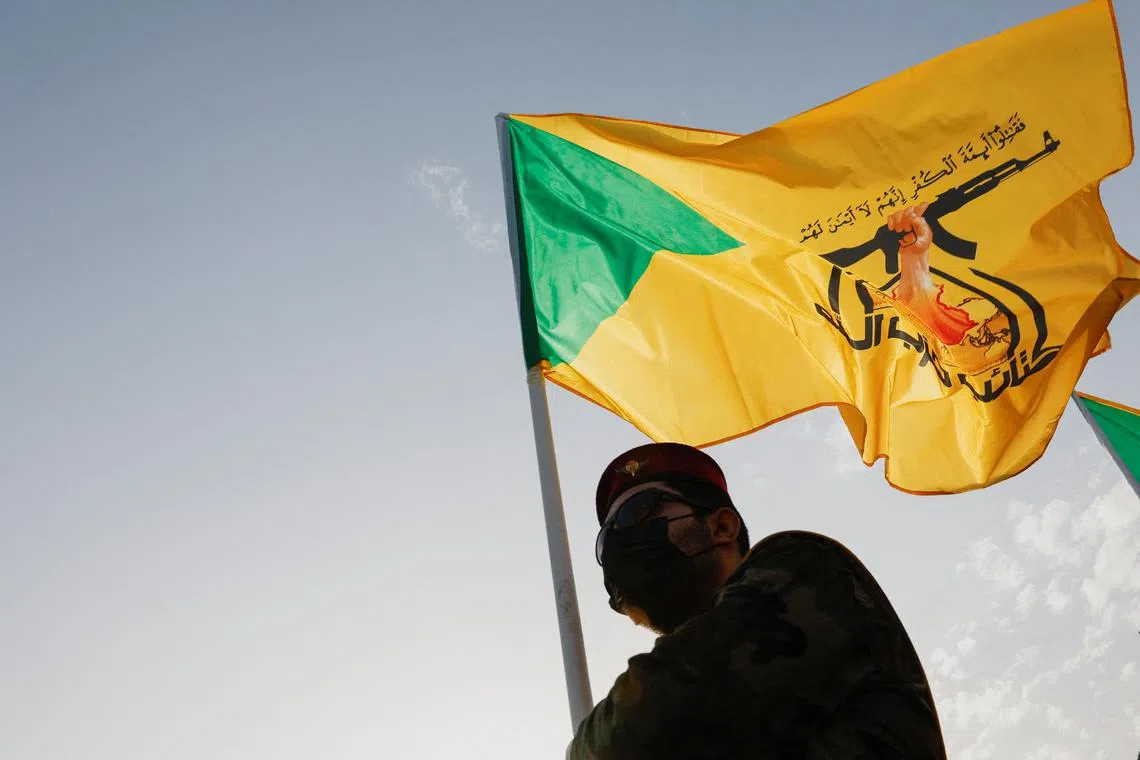 FILE PHOTO: A mourner attends the funeral of a commander from Iraq's Kataib Hezbollah armed group who was killed in what they called a \"Zionist attack\" in the Syrian capital Damascus on Friday, during a funeral in Baghdad, Iraq September 22, 2024. REUTERS/Thaier Al-Sudani/File Photo