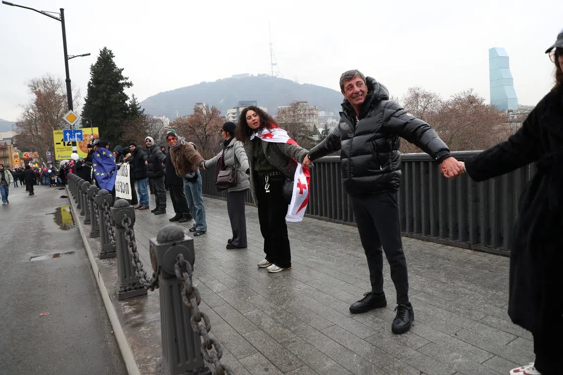 Thousands of protesters formed a human in Georgia's capital, Tbilisi, on Dec 28. 