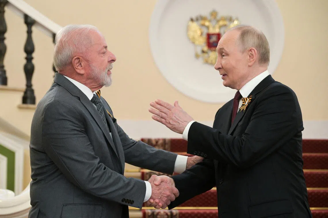 FILE PHOTO: Russian President Vladimir Putin greets Brazilian President Luiz Inacio Lula da Silva before a military parade on Victory Day, marking the 80th anniversary of the victory over Nazi Germany in World War Two, in Moscow, Russia, May 9, 2025. Alexei Nikolsky/Host agency RIA Novosti/Handout via REUTERS/File Photo