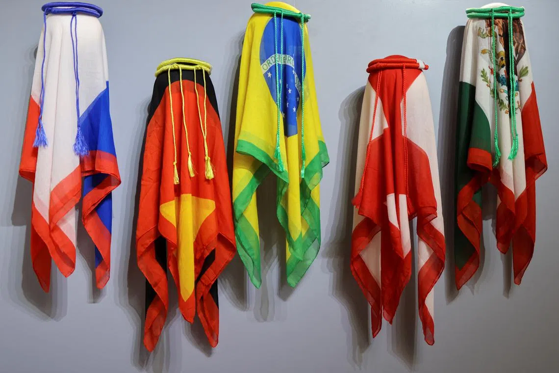 Traditional Arab head dresses with colors of international flags are seen at an underground metro shop, ahead of the FIFA World Cup 2022 soccer tournament in Doha, Qatar November 13, 2022. 

