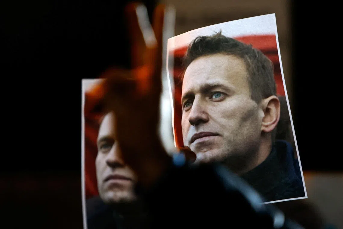 A person gestures in front of portraits of Russian opposition leader Alexei Navalny as people attend a protest and vigil held in front of the Russian embassy following the death of Navalny, in Kappara, Malta, February 19, 2024. REUTERS/Darrin Zammit Lupi/File photo
