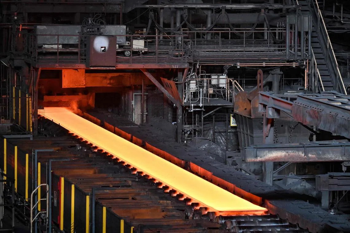 This general view shows steel moving along rollers at the hot rolling mill (rough rolling) during a media tour by Japanese company Nippon Steel at its  East Nippon Works Kashima Area facility in Kashima, Ibaraki prefecture, north of Tokyo on Dec 6, 2024. 