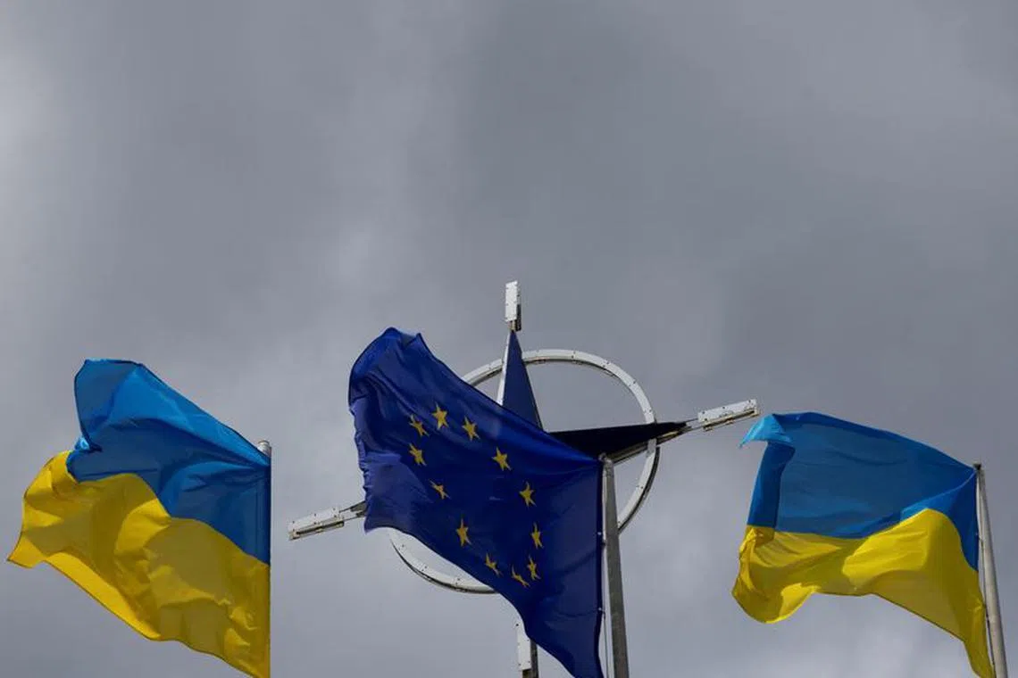 National flags of Ukraine and European Union rise in front of the NATO emblem, amid Russia's attack on Ukraine, in central Kyiv, Ukraine July 11, 2023. REUTERS/Valentyn Ogirenko