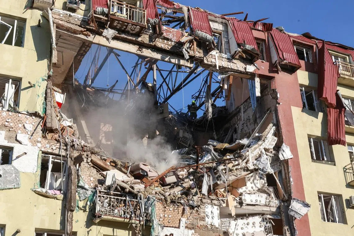 Rescuers work at a site an apartment building hit by a Russian drone strike, amid Russia's attack on Ukraine, in Odesa, Ukraine April 6, 2026. REUTERS/Nina Liashonok