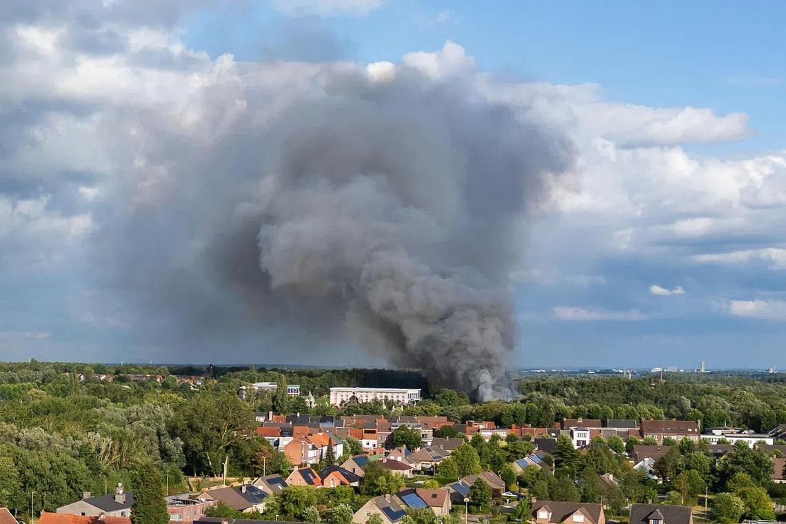 Smoke caused by a fire billows above the site of the Tomorrowland electronic music festival in Boom, northern Belgium on July 16.
