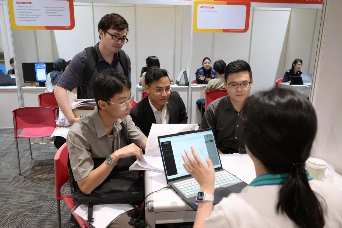 Embargoed until 4pm, Aug 15, 2025.

Computer science graduates (L-R), Oliver Syn, 25, Louis Mineo, 26, Noah Ng, 26, and Eugene Ho (back) 29, at NTUC?s Employment and Employability Institute?s (e2i) University Graduate Fair on Aug 15, 2025.